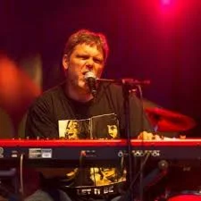 Roy performing with intense red lighting